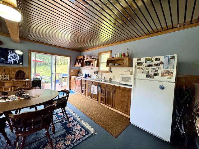 106 Philbrook Rd, Pittsburg, NH 03592 - carpeted dining area with wood ceiling, wainscoting, wooden walls, and a sink