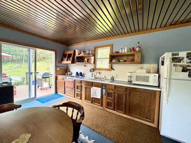 106 Philbrook Rd, Pittsburg, NH 03592 - kitchen with white appliances, open shelves, light countertops, and carpet floors