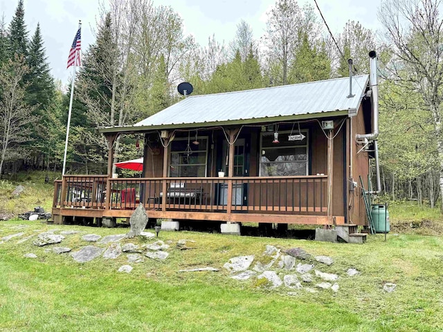 106 Philbrook Rd, Pittsburg, NH 03592 - view of front of home with metal roof and a front lawn