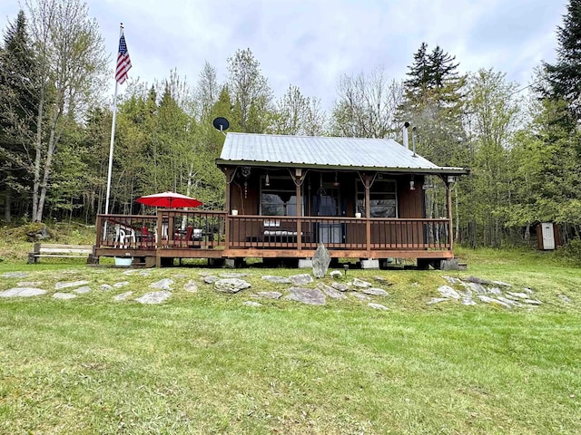 106 Philbrook Rd, Pittsburg, NH 03592 - back of property with a yard, metal roof, and a wooden deck