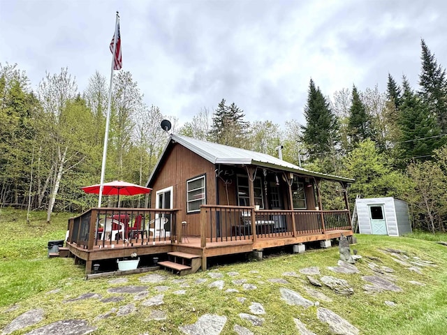 106 Philbrook Rd, Pittsburg, NH 03592 - back of property with a deck, metal roof, and a yard