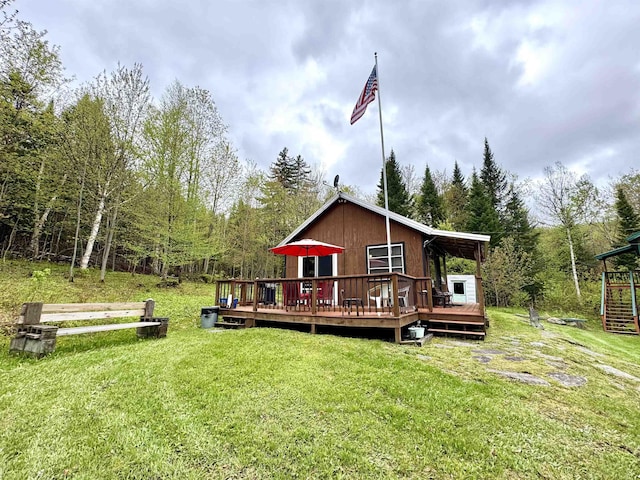 106 Philbrook Rd, Pittsburg, NH 03592 - back of house featuring a deck, a lawn, and a forest view