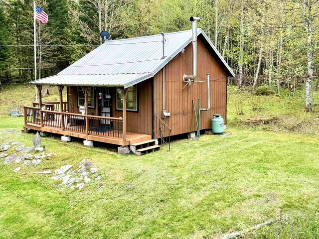 106 Philbrook Rd, Pittsburg, NH 03592 - back of property featuring a yard, a view of trees, and metal roof