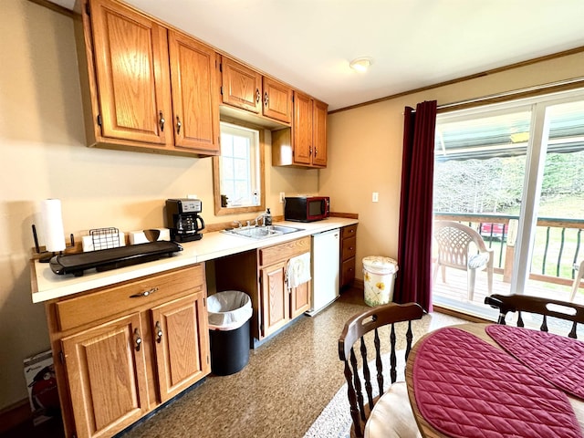 106 Philbrook Rd, Pittsburg, NH 03592 - kitchen featuring white dishwasher, light countertops, a sink, black microwave, and brown cabinets