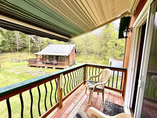 106 Philbrook Rd, Pittsburg, NH 03592 - wooden deck with a yard and a wooded view