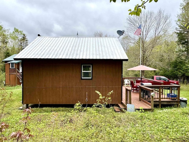 106 Philbrook Rd, Pittsburg, NH 03592 - view of property exterior with a wooden deck and metal roof