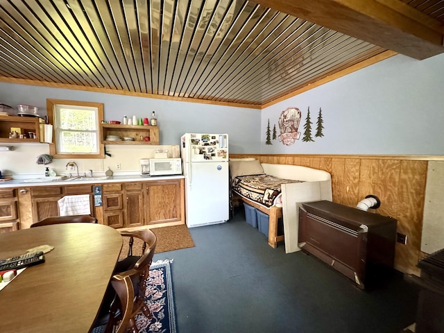 106 Philbrook Rd, Pittsburg, NH 03592 - kitchen with white appliances, open shelves, wooden ceiling, brown cabinetry, and a wainscoted wall