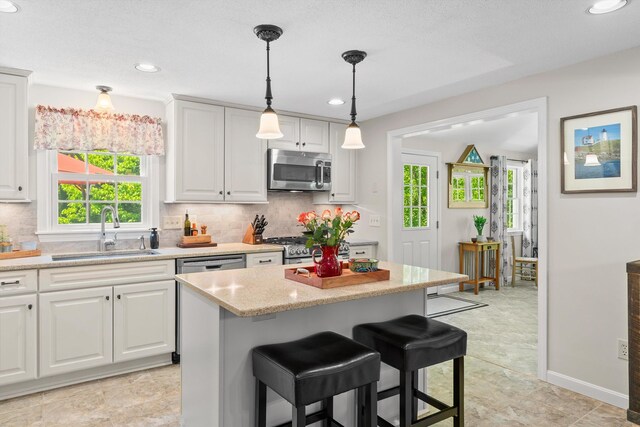 37 Forest St, Londonderry, NH 03053 - kitchen with appliances with stainless steel finishes, a sink, tasteful backsplash, plenty of natural light, and recessed lighting