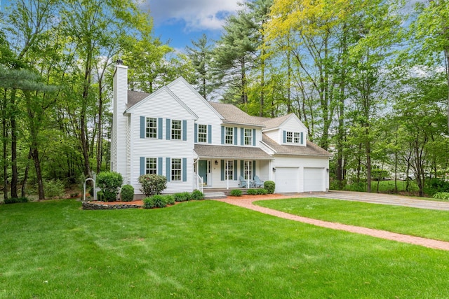 15 Fox Meadow Ln, Merrimack, NH 03054 - view of front of house featuring a porch, a chimney, driveway, a front lawn, and a shingled roof