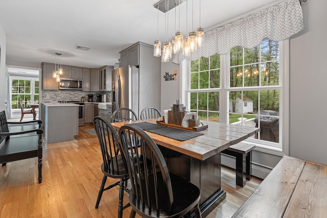 15 Fox Meadow Ln, Merrimack, NH 03054 - dining room with light wood finished floors, a chandelier, and baseboard heating