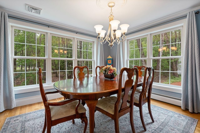 15 Fox Meadow Ln, Merrimack, NH 03054 - dining space featuring a chandelier, light wood-style floors, ornamental molding, baseboard heating, and baseboards