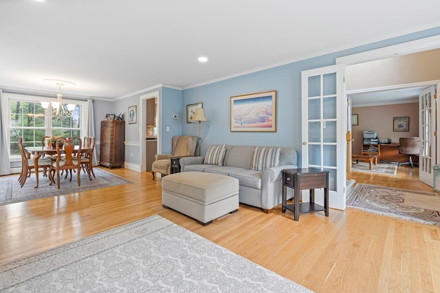 15 Fox Meadow Ln, Merrimack, NH 03054 - living area featuring light wood finished floors, a chandelier, ornamental molding, baseboards, and an office area