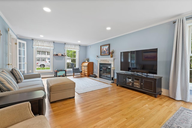 15 Fox Meadow Ln, Merrimack, NH 03054 - living area with crown molding, light wood-type flooring, a glass covered fireplace, recessed lighting, and baseboard heating