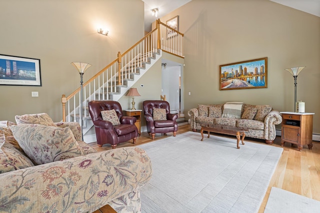 15 Fox Meadow Ln, Merrimack, NH 03054 - living room featuring light wood-style flooring, stairs, and a high ceiling
