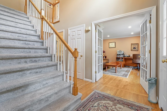 15 Fox Meadow Ln, Merrimack, NH 03054 - foyer entrance with french doors, stairs, wood finished floors, crown molding, and baseboards
