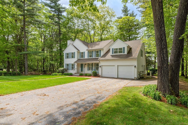 15 Fox Meadow Ln, Merrimack, NH 03054 - view of front of home featuring driveway, covered porch, a front yard, roof with shingles, and a chimney