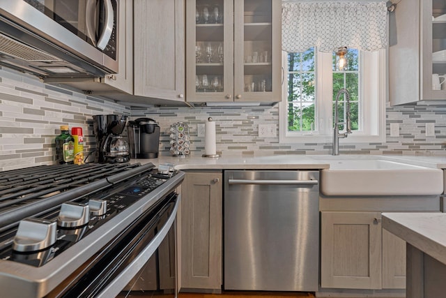 15 Fox Meadow Ln, Merrimack, NH 03054 - kitchen with stainless steel appliances, backsplash, a sink, and glass insert cabinets