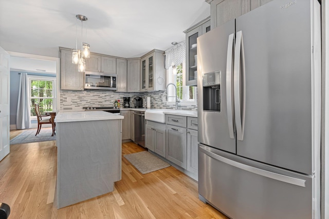15 Fox Meadow Ln, Merrimack, NH 03054 - kitchen with stainless steel appliances, gray cabinetry, a sink, tasteful backsplash, and glass insert cabinets