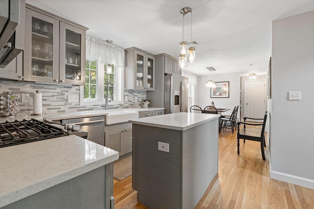 15 Fox Meadow Ln, Merrimack, NH 03054 - kitchen featuring stainless steel appliances, gray cabinets, decorative backsplash, and light wood finished floors