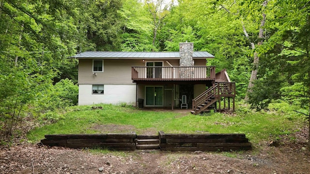 19 Alpendorf Loop, Bartlett, NH 03812 - back of property featuring a wooden deck, stairway, a view of trees, a chimney, and metal roof
