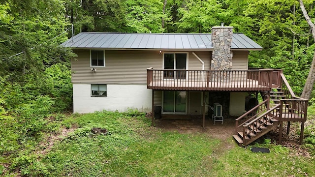 19 Alpendorf Loop, Bartlett, NH 03812 - back of house featuring a standing seam roof, stairway, a wooden deck, a chimney, and metal roof