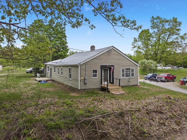 450 Leighton Corner Rd, Wakefield, NH 03872 - view of front of property with a chimney, metal roof, and a front yard