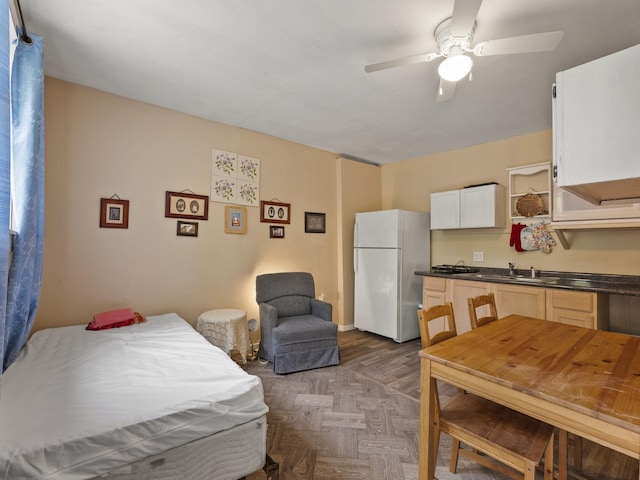 450 Leighton Corner Rd, Wakefield, NH 03872 - bedroom with freestanding refrigerator, a sink, and a ceiling fan