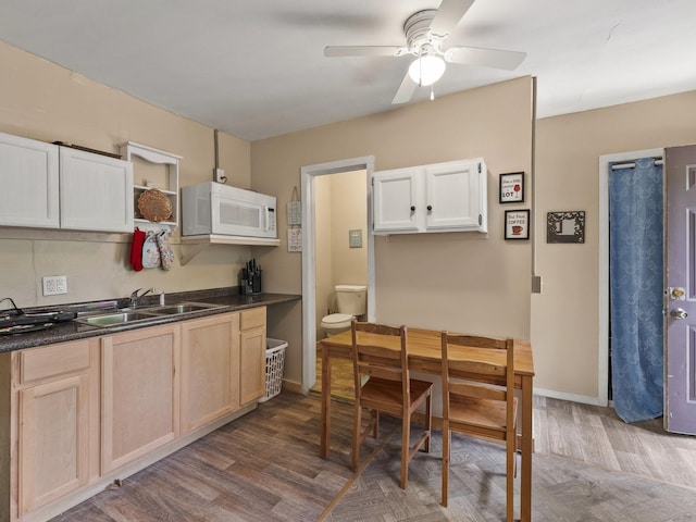 450 Leighton Corner Rd, Wakefield, NH 03872 - kitchen with white microwave, a sink, ceiling fan, and dark countertops