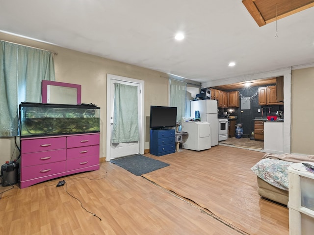 450 Leighton Corner Rd, Wakefield, NH 03872 - living area with attic access, light wood-type flooring, washer / clothes dryer, and recessed lighting