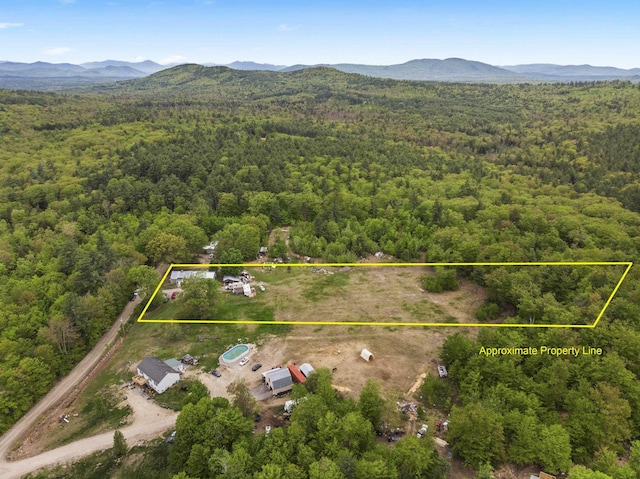450 Leighton Corner Rd, Wakefield, NH 03872 - aerial view of property and surrounding area with a heavily wooded area, a mountainous background, and property boundaries highlighted