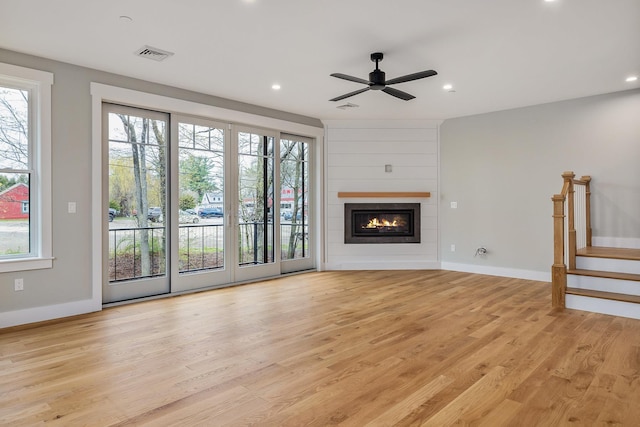 22 Little Bay Dr, Dover, NH 03820 - unfurnished living room featuring light wood-style flooring, a ceiling fan, a glass covered fireplace, baseboards, and recessed lighting