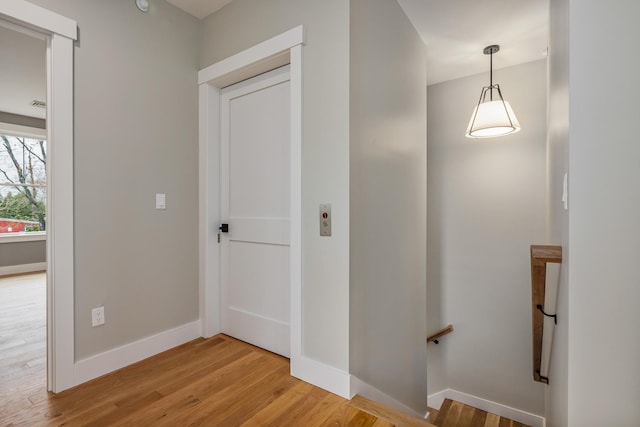 22 Little Bay Dr, Dover, NH 03820 - hall featuring an upstairs landing, light wood-type flooring, and baseboards
