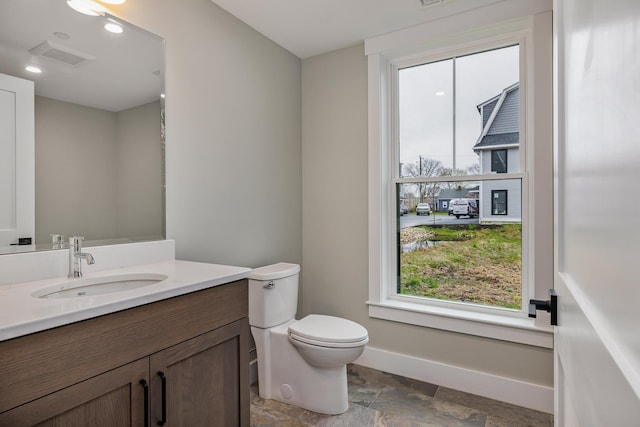 22 Little Bay Dr, Dover, NH 03820 - bathroom with stone tile floors, plenty of natural light, baseboards, and vanity