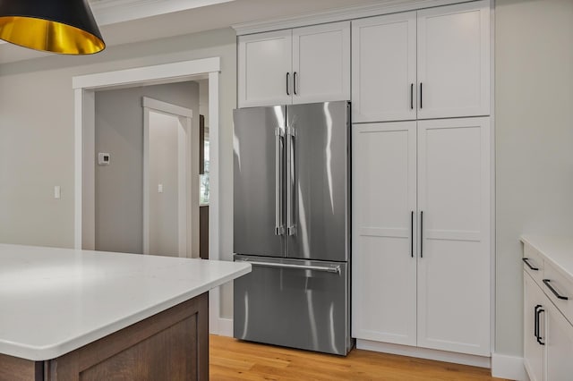 22 Little Bay Dr, Dover, NH 03820 - kitchen with high end refrigerator, light wood-type flooring, and white cabinets