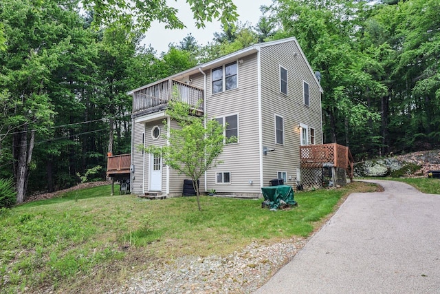 29 Isaac Frye Hwy, Wilton, NH 03086 - view of side of home featuring a balcony, a yard, and asphalt driveway
