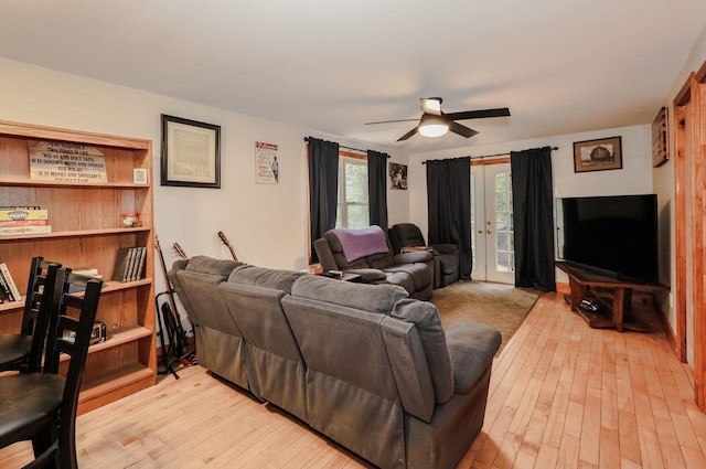 29 Isaac Frye Hwy, Wilton, NH 03086 - living room with french doors, a ceiling fan, and light wood-style flooring