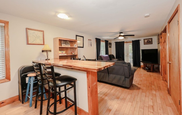 29 Isaac Frye Hwy, Wilton, NH 03086 - kitchen with wooden counters, light wood finished floors, a kitchen breakfast bar, ceiling fan, and a peninsula