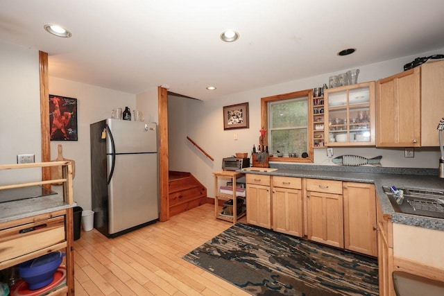 29 Isaac Frye Hwy, Wilton, NH 03086 - kitchen with freestanding refrigerator, light brown cabinetry, light wood-style floors, glass insert cabinets, and dark countertops