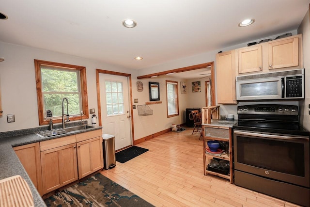 29 Isaac Frye Hwy, Wilton, NH 03086 - kitchen with appliances with stainless steel finishes, a sink, baseboards, light wood-style flooring, and light brown cabinetry