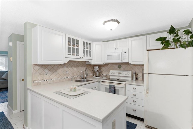 7 Daniel Plummer Rd Unit E, Goffstown, NH 03045 - kitchen with white appliances, a sink, white cabinetry, glass insert cabinets, and tasteful backsplash