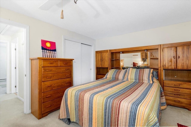 7 Daniel Plummer Rd Unit E, Goffstown, NH 03045 - bedroom with light colored carpet, a closet, and a ceiling fan