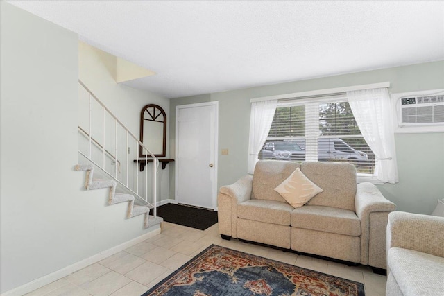 7 Daniel Plummer Rd Unit E, Goffstown, NH 03045 - living area featuring stairway, tile patterned flooring, baseboards, and a wall mounted air conditioner