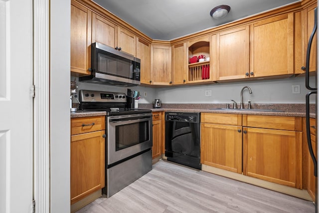 58 Branch Tpke Unit 69Aka A22, Concord, NH 03301 - kitchen featuring stainless steel appliances, a sink, light wood-type flooring, open shelves, and brown cabinetry