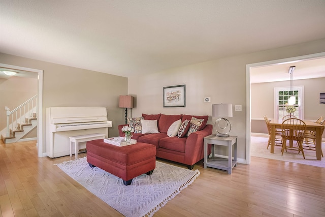 16 Pulpit Run, Amherst, NH 03031 - living room with light wood-type flooring, stairway, and baseboards