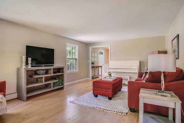 16 Pulpit Run, Amherst, NH 03031 - living room featuring wood finished floors, a baseboard heating unit, and baseboards