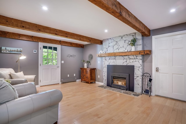 16 Pulpit Run, Amherst, NH 03031 - living room featuring a baseboard heating unit, beamed ceiling, wood finished floors, a fireplace, and baseboards