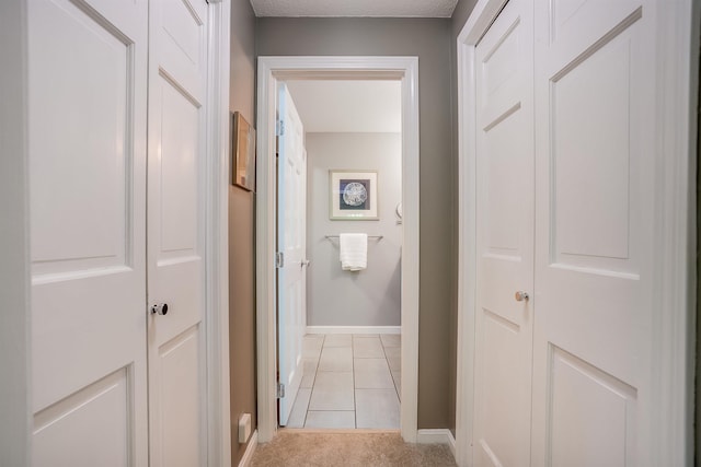 16 Pulpit Run, Amherst, NH 03031 - corridor with baseboards, light tile patterned floors, and light carpet