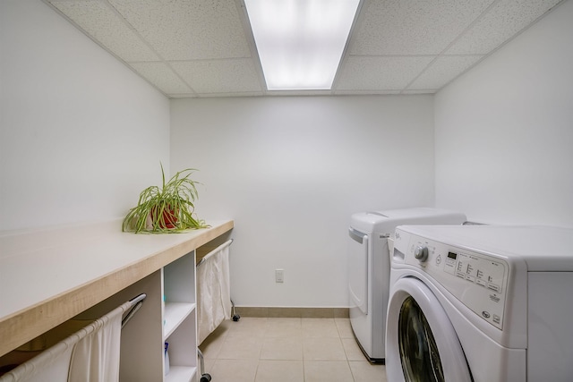 16 Pulpit Run, Amherst, NH 03031 - washroom with washer and dryer, baseboards, and light tile patterned flooring