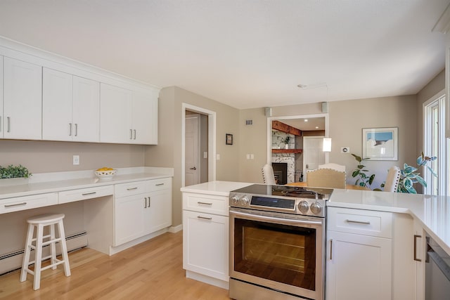 16 Pulpit Run, Amherst, NH 03031 - kitchen with stainless steel appliances, light wood-type flooring, a fireplace, white cabinets, and light countertops