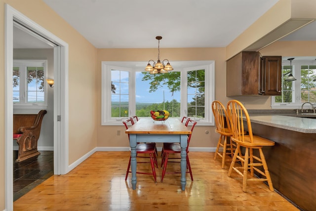 223 Deering Center Rd, Deering, NH 03244 - dining area featuring a chandelier, plenty of natural light, light wood-style floors, and baseboards